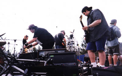 Photo of us setting up at Spring Scream while Jimi gamely reads the not terribly flattering review of Dribdas in the Ugly American.